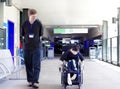 Father walking with disabled son in wheelchair to the hospital Royalty Free Stock Photo