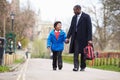 Father Walking Son To School Along Path