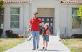 Father walking son to school. Parent and pupil of primary school schoolboy. Dad and cild go beginning of lessons.