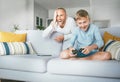 Father watching his son playing TV video game using the gamepad Royalty Free Stock Photo