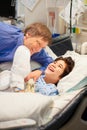 Father watching over disabled son in hospital bed Royalty Free Stock Photo