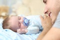 Father watching to her baby sleeping on bed