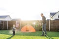 Father is watering his toddler boy from hose Royalty Free Stock Photo