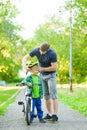 Father wears a protective helmet to his son