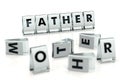 FATHER word written on glossy blocks and fallen over blurry blocks with MOTHER letters. Isolated on white. Tho one in family who