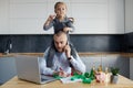 Father Working from home on laptop during quarantine. Little child girl make noise and distracts father from work Royalty Free Stock Photo