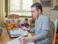 Father working in home office and son playing Royalty Free Stock Photo