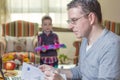 Father working in home office and son playing Royalty Free Stock Photo