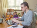 Father working in home office and son playing Royalty Free Stock Photo