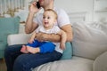 Father working, talking on phone and babysitting Royalty Free Stock Photo