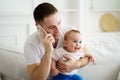 Father working, talking on phone and babysitting Royalty Free Stock Photo