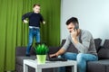 Father works on a laptop at home, his son bothers him. Businessman working from home and looking after a child, spending time with Royalty Free Stock Photo