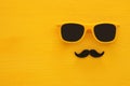 Father& x27;s day concept. Hipster yellow sunglasses and funny moustache