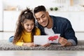 Father's Day Greeting. Happy Arab Man Holding Greeting Card From Little Daughter Royalty Free Stock Photo