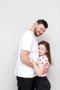 father& x27;s day. side view affectionate little child daughter is hugging smiling bearded father. Happy small kid girl