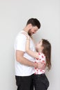 father& x27;s day. side view affectionate little child daughter is hugging smiling bearded father. Happy small kid girl