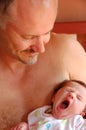 Father and yawning newborn baby