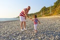 Father and 2 years son in similar clothes walk on the seaside Royalty Free Stock Photo