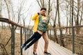 Father in yellow raincoat and son having fun in forest. Happy family with child kid boy playing and having fun outdoors Royalty Free Stock Photo