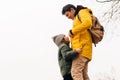 Father in yellow raincoat and son having fun in forest. Happy family with child kid boy playing and having fun outdoors Royalty Free Stock Photo