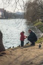 Father with a young child on the Bank of the Novodevichy pond. Moscow.