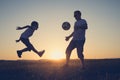 Father and young little boy playing in the field  with soccer ball Royalty Free Stock Photo