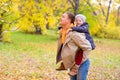 Father With Young Son On his back Autumn Park Royalty Free Stock Photo