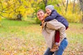 Father With Young Son On his back Autumn Park Royalty Free Stock Photo