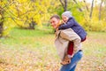 Father With Young Son On his back Autumn Park Royalty Free Stock Photo
