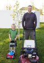 Father and Young Son mowing the lawn together Royalty Free Stock Photo