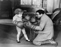 Father and young son playing with boxing gloves Royalty Free Stock Photo