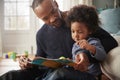 Father And Young Son Reading Book Together At Home Royalty Free Stock Photo