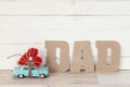 Fathers day background with miniature blue toy car carrying a he Royalty Free Stock Photo