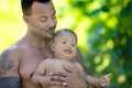 Fathers day. Close up portrait of african american father kissing multiracial baby. Father kiss Biracial child. Closeup