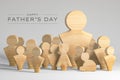Fathers day greeting card - big family wooden figures father and children as unity social values Royalty Free Stock Photo