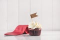 Fathers day concept. Delicious creative cupcake, tie on table.