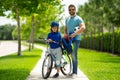 Fathers day concept. Father helping son get ready for school. Father and son on bicycle on summer day outdoor. Little