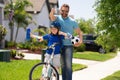 Fathers day concept. Father and son in bike helmet learning ride bicycle. Sporty family. Excited father and son with Royalty Free Stock Photo