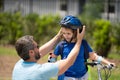 Fathers day concept. Father and son in bike helmet learning ride bicycle. Father and son on bicycle on summer day Royalty Free Stock Photo