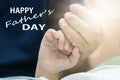 Fathers day concept, father and son hold hands with love.
