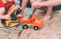 Fathers day. Dad and son. Little son plays toys with dad on the beach with sand. Royalty Free Stock Photo