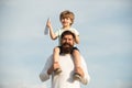 Fathers day. Dad and son playing together. Portrait of happy father giving son piggyback ride on his shoulders and Royalty Free Stock Photo