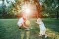 Fathers Day. Father playing ball with toddler baby boy outdoors. Parent spending time together with child son in park. Authentic Royalty Free Stock Photo