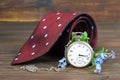 Fathers Day gift. Tie, flowers and vintage pocket watch on wooden background Royalty Free Stock Photo