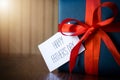 Fathers day. Gift package wrapped with blue paper and rope with a red ribbon on wooden background Royalty Free Stock Photo