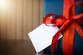 Fathers day. Gift package wrapped with blue paper and rope with a red ribbon on wooden background. Copyspace Royalty Free Stock Photo