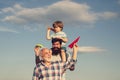 Fathers day - grandfather, father and son are hugging and having fun together. Airplane ready to fly. Portrait of happy