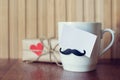Greeting card on Cup with funny mustache over wooden board. Fathers day. Happy birthday. Valentines day. Mockup