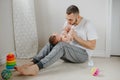 Fathers Day holiday. Caucasian father playing kissing  newborn baby. Parent holding rocking cute funny child daughter, son. Royalty Free Stock Photo