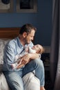 Fathers Day holiday. Middle age Caucasian father with sleeping newborn baby girl. Parent holding rocking child daughter son in Royalty Free Stock Photo